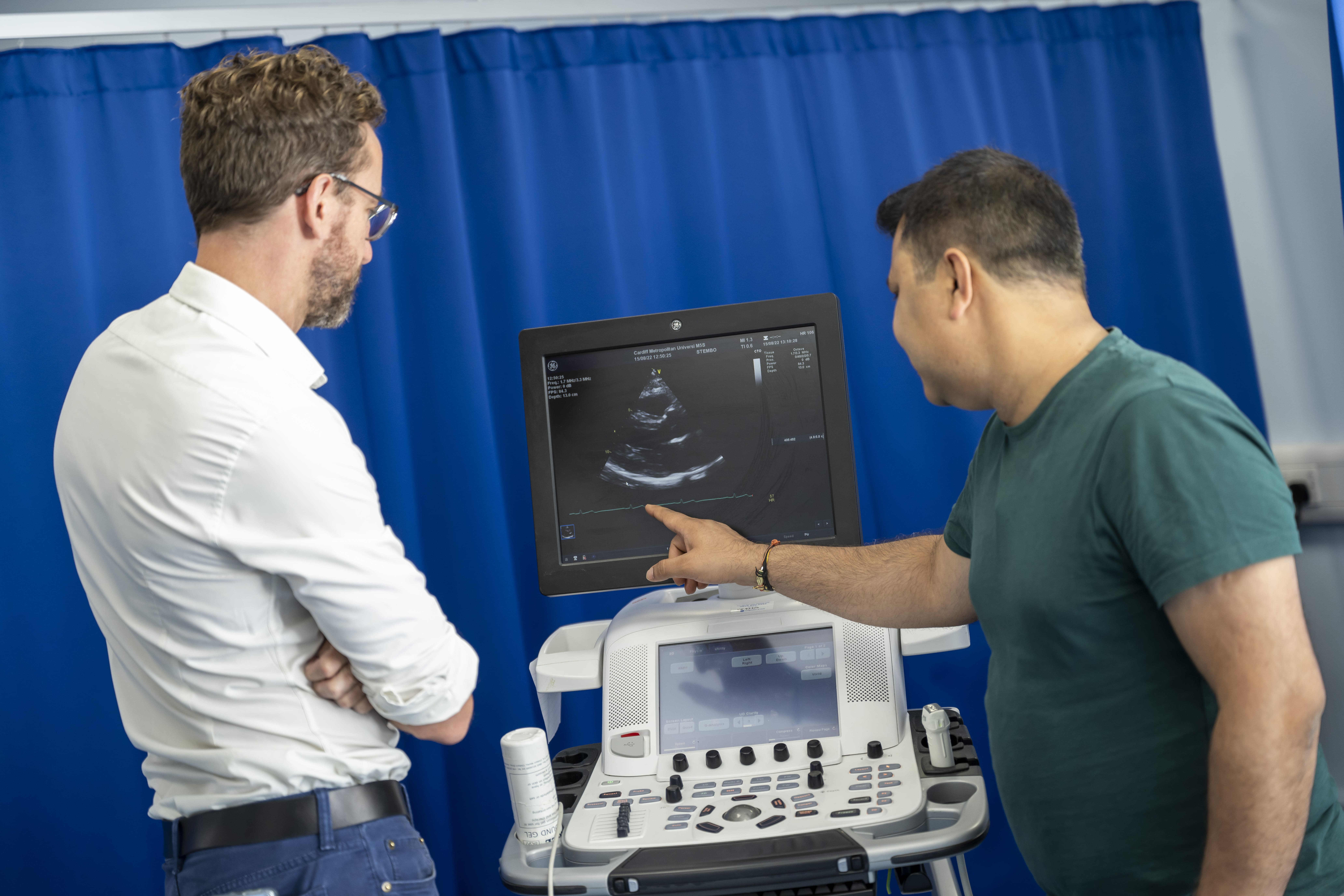 Two doctors looking at heart scan 