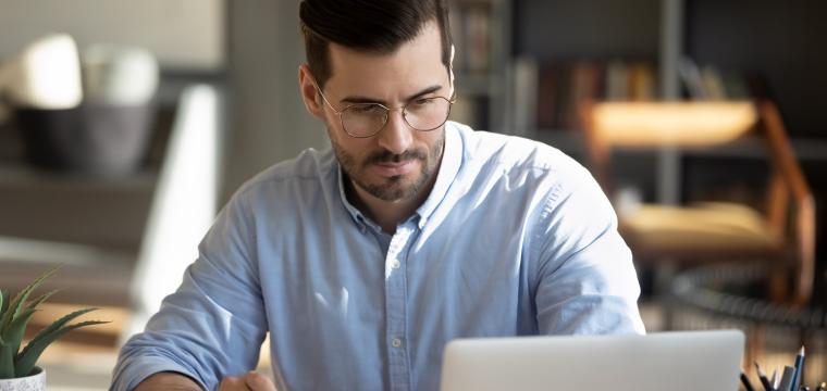 Business owner with laptop and calculator