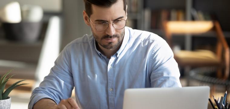 business owner with laptop and calculator