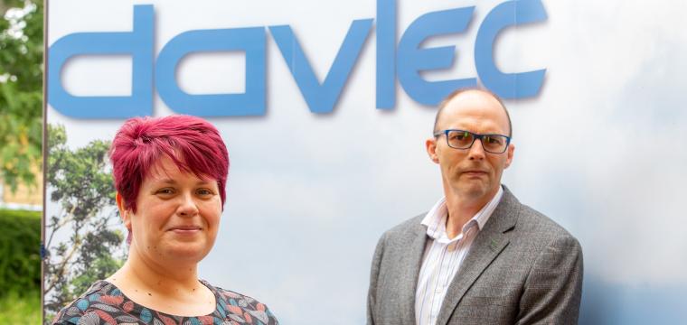 Nia Davies Managing Director and Stewart Williams stood infront of Davlec Logo