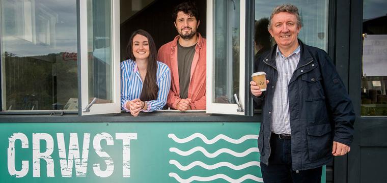 Osian Jones, Catrin Parry Jones, and Richard Easton standing by the Crwst cafe