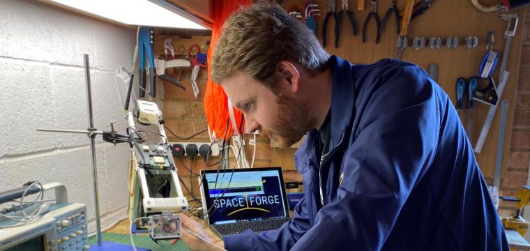 Space Forge co-founder Andrew Bacon working in garage