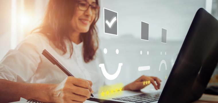 Person collating customer feedback at a laptop