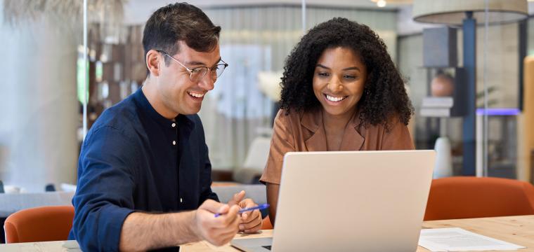 Two colleagues working on a laptop