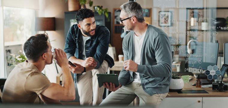 Colleagues chatting around a desk