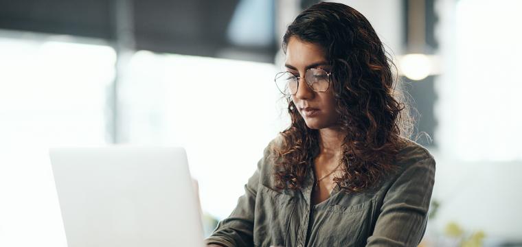 A woman working at a laptop
