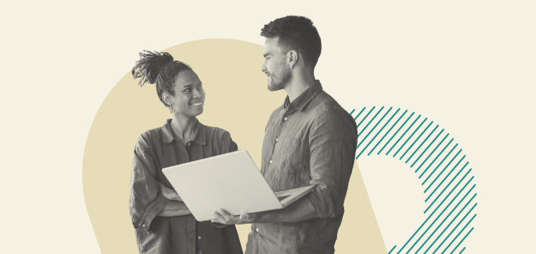 Two colleagues discussing work on a laptop