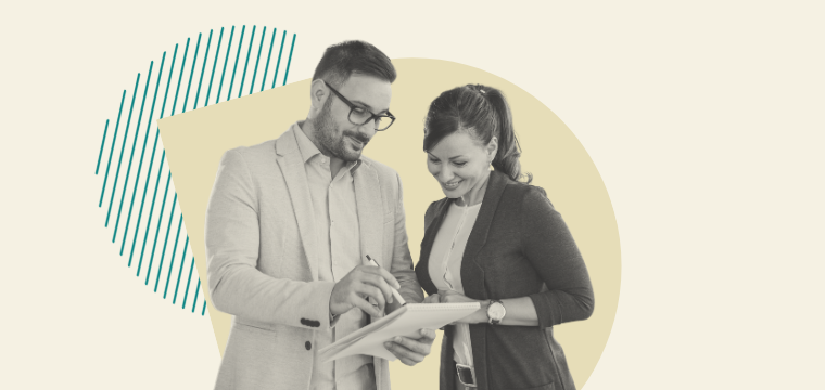 Two people reviewing a paper pad