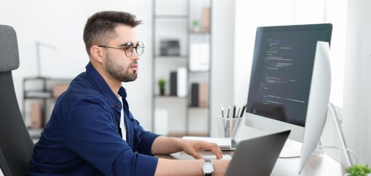 A website developer working on a computer