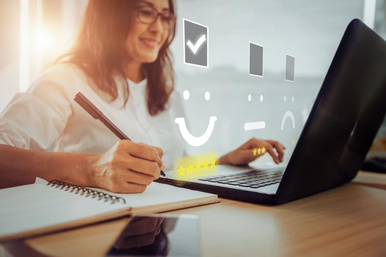 Person collating customer feedback at a laptop