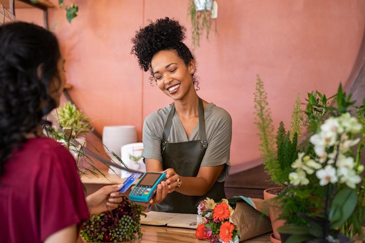 Woman taking card payment in a shop