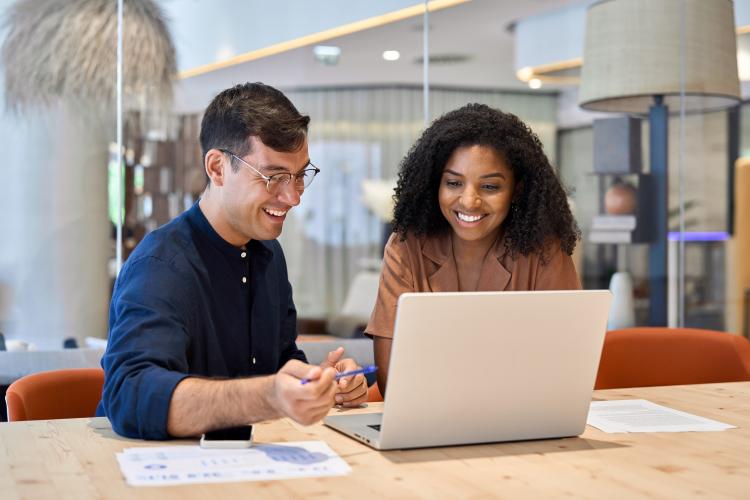 Two colleagues working on a laptop