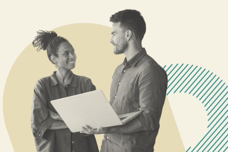 Two colleagues discussing work on a laptop