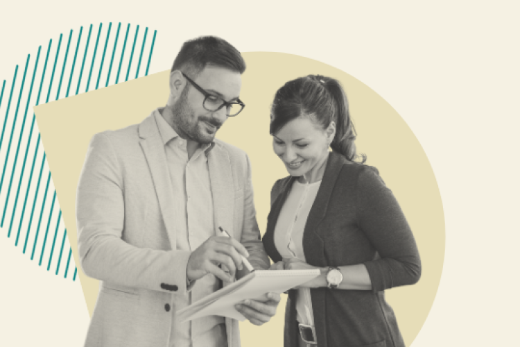 Two people reviewing a paper pad