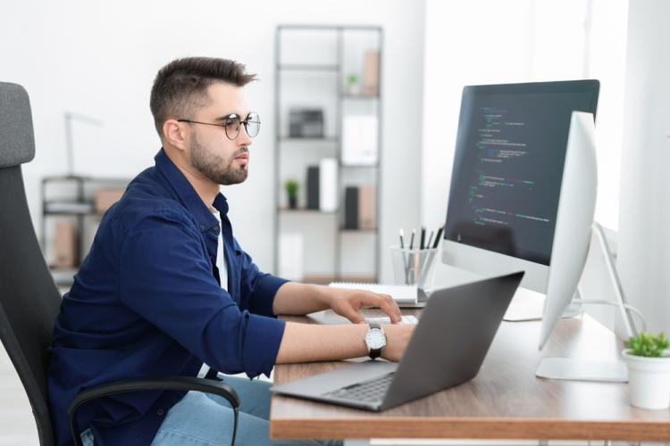 A website developer working on a computer